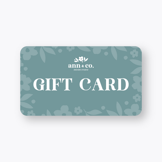 Gift card with floral design and 'ann & co.' branding on a light gray background